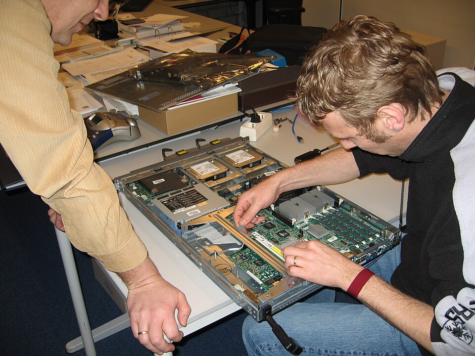 2 people working on a computer