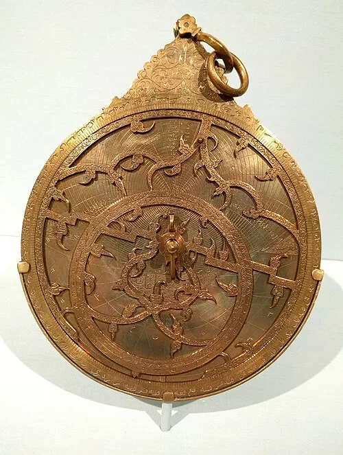 A brass Persian astrolabe, intricately engraved, used centuries ago to solve problems in astronomy and navigation